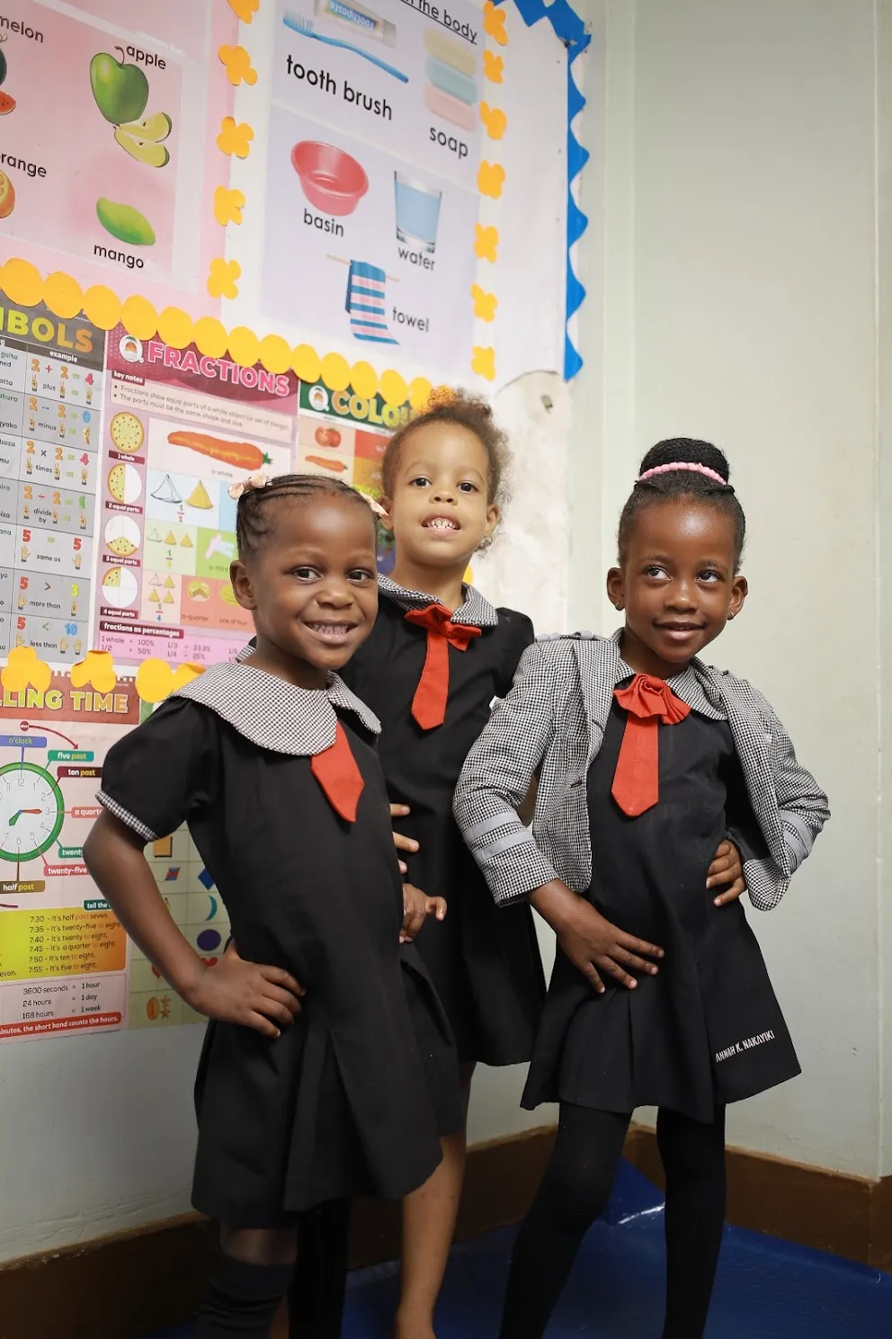 Classmates posing proudly in their uniforms