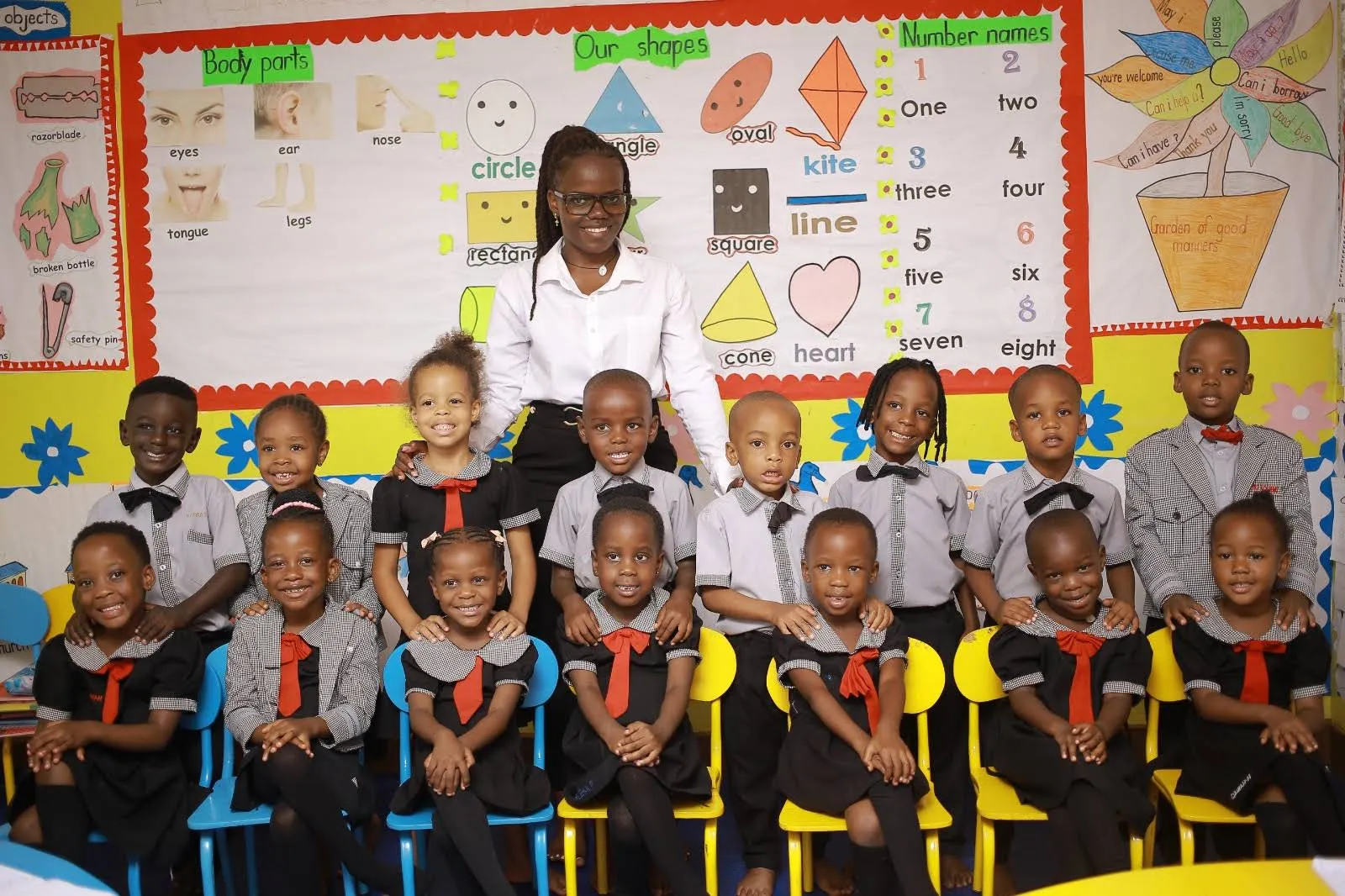 A Marvels Academy class with their teacher in a bright, decorated classroom